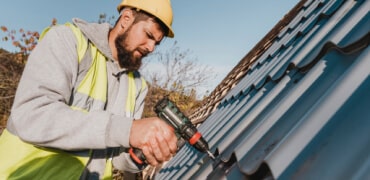 Technician repairing roof shingles